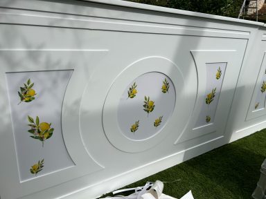 Mur blanc décoré de motifs de citrons jaunes sur fond blanc.